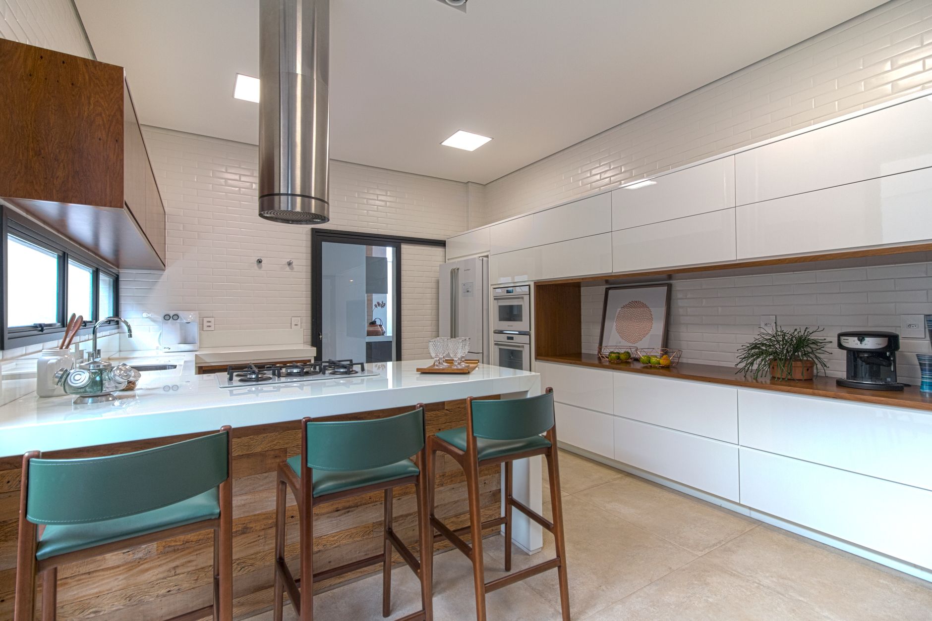 Elegant kitchen featuring white cabinetry and a central island with bar stools.