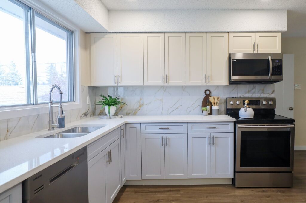 A contemporary kitchen with sleek cabinetry and stainless steel appliances, featuring ample natural light.