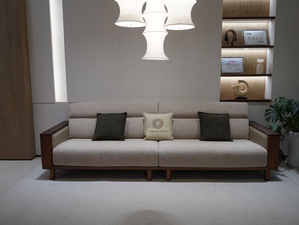 Stylish modern living room featuring a beige sofa, artistic ceiling light, and decorative elements.