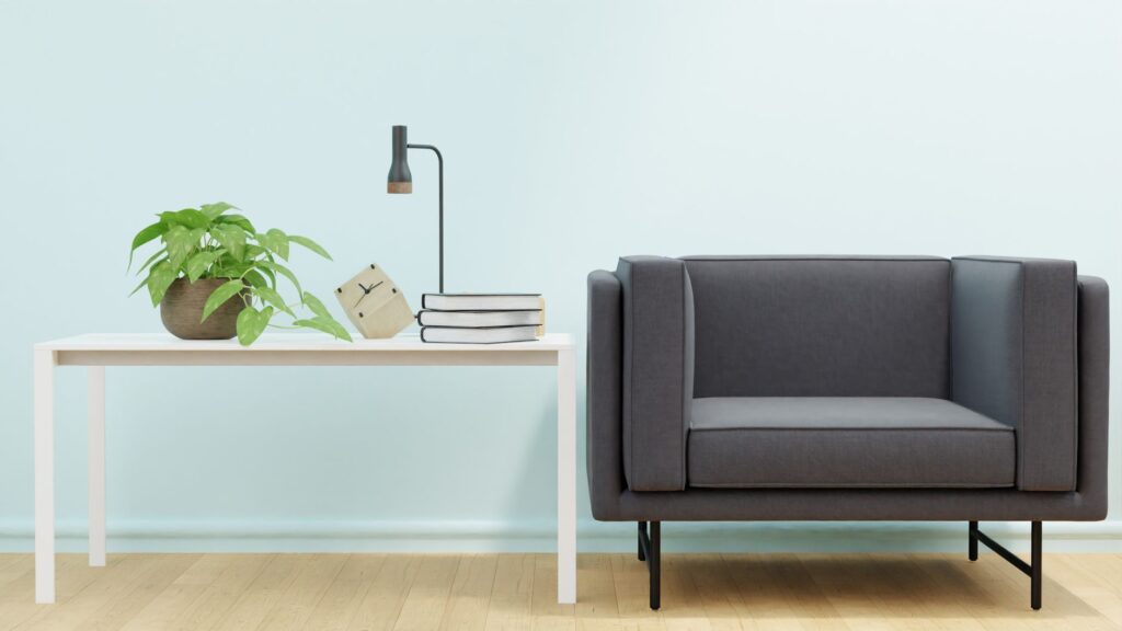 Elegant living room setup with a modern sofa, white table, and indoor plant.