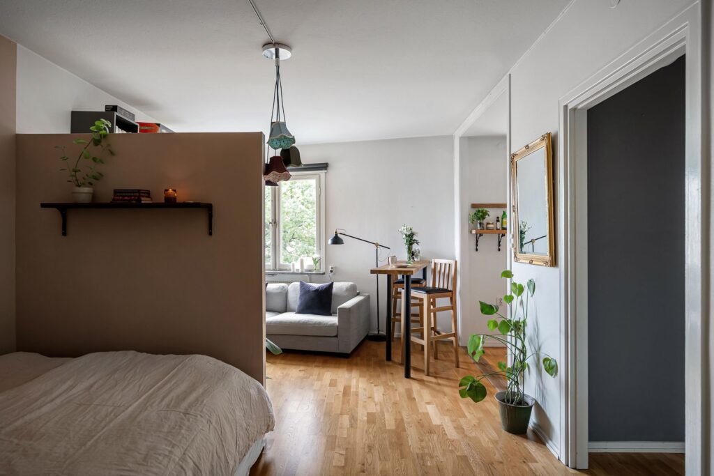 A cozy modern interior featuring a comfortable seating area, plants, and stylish accessories.